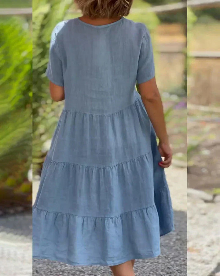 Woman wearing the Bonnie™ V-neck summer dress with a soft layered skirt, strolling on a sunny afternoon.