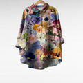 Woman wearing a patterned blouse with a soft, flowing summer silhouette.