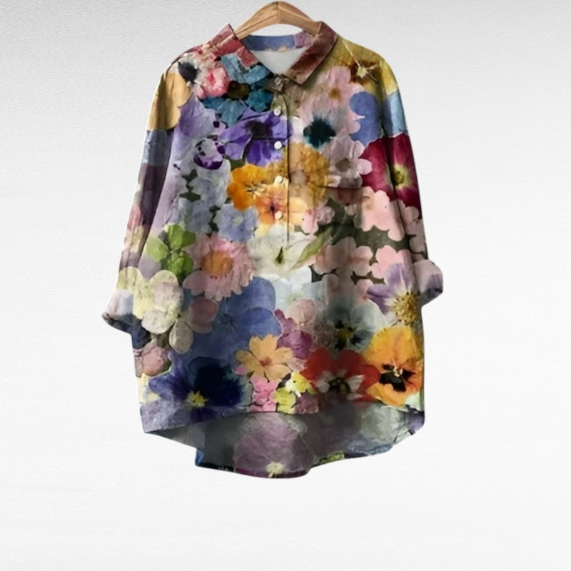 Woman wearing a patterned blouse with a soft, flowing summer silhouette.