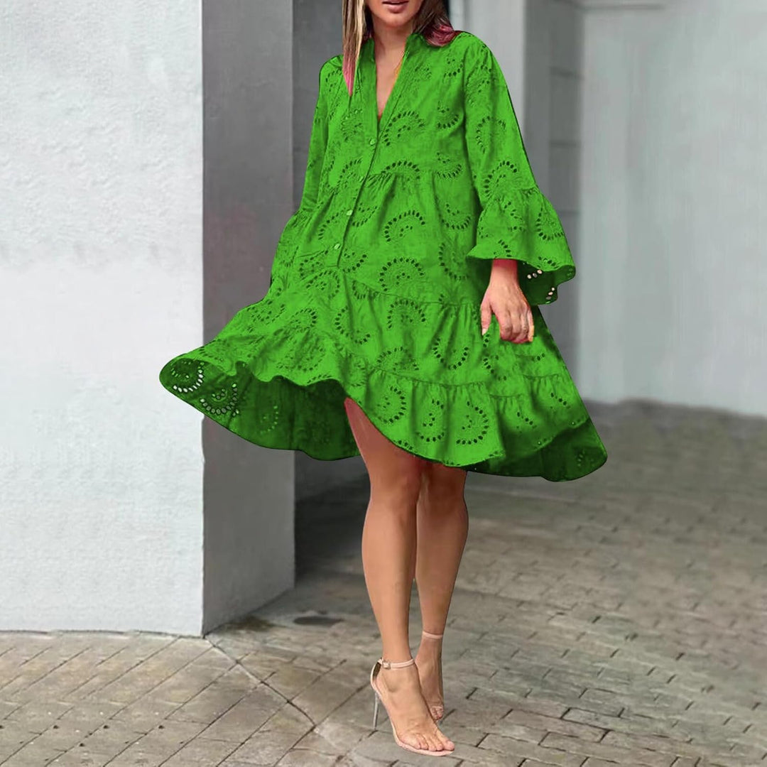 Woman in a breezy mini dress with delicate eyelet detailing and softly tiered skirt.