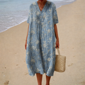 A woman in a printed summer dress with a light, swaying skirt, enjoying a sunny day.