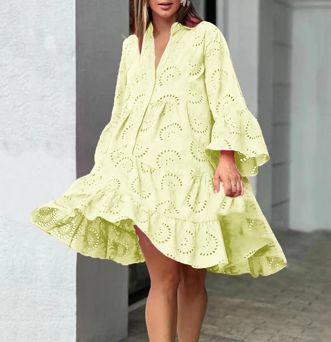 Woman in a breezy mini dress with delicate eyelet detailing and softly tiered skirt.
