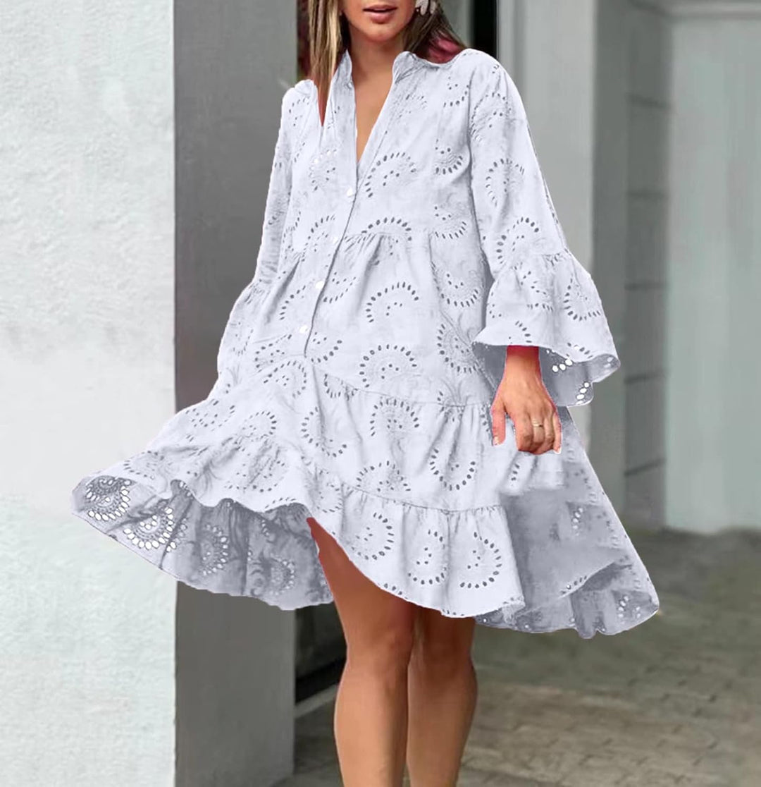 Woman in a breezy mini dress with delicate eyelet detailing and softly tiered skirt.