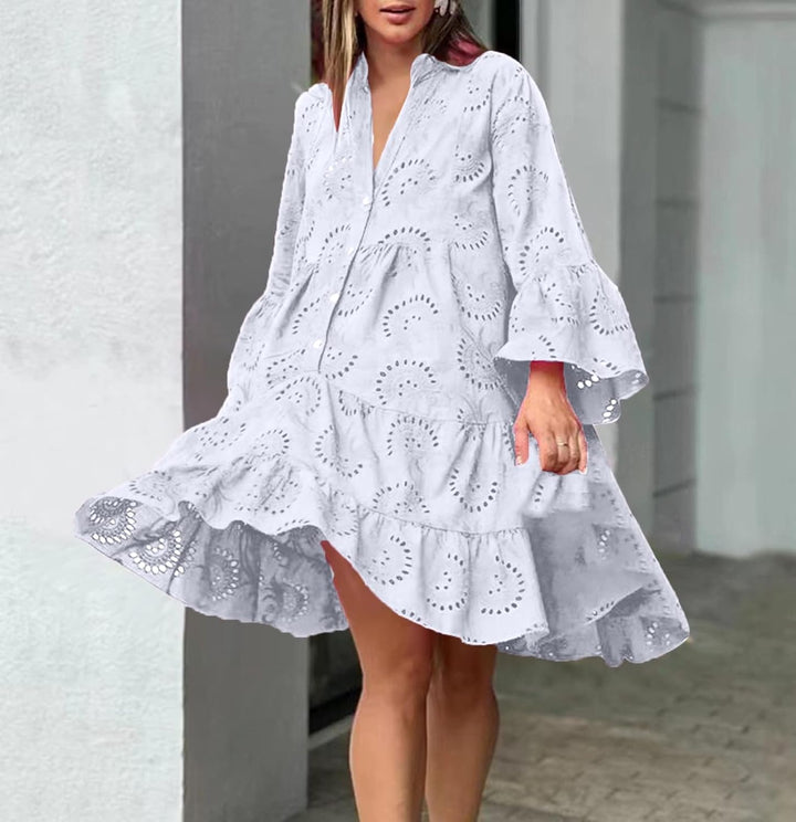 Woman in a breezy mini dress with delicate eyelet detailing and softly tiered skirt.