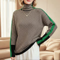 A woman wearing a brown and beige chevron high-collar sweater with bright green side stripes.