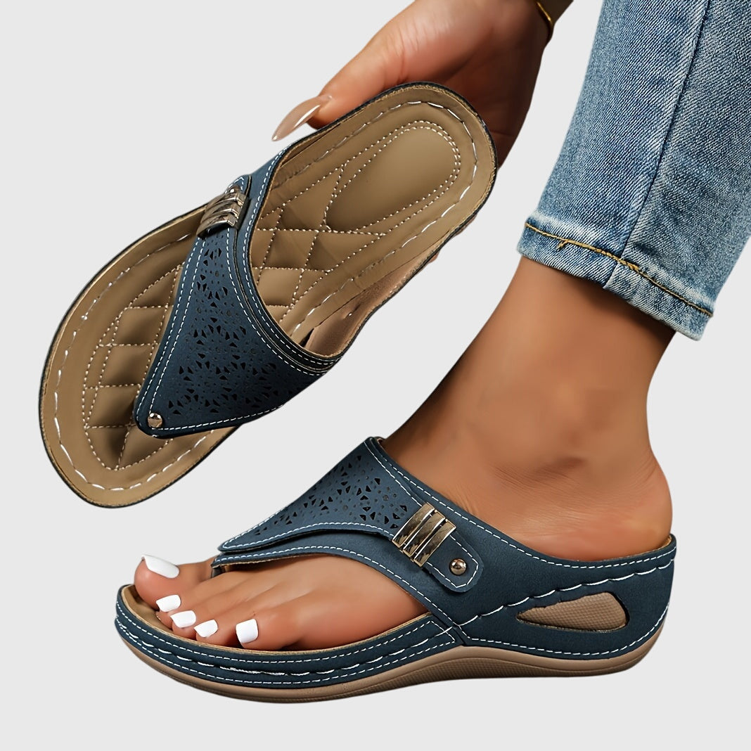 A woman in grey comfort flip-flops relaxing outdoors, feet cushioned and supported.