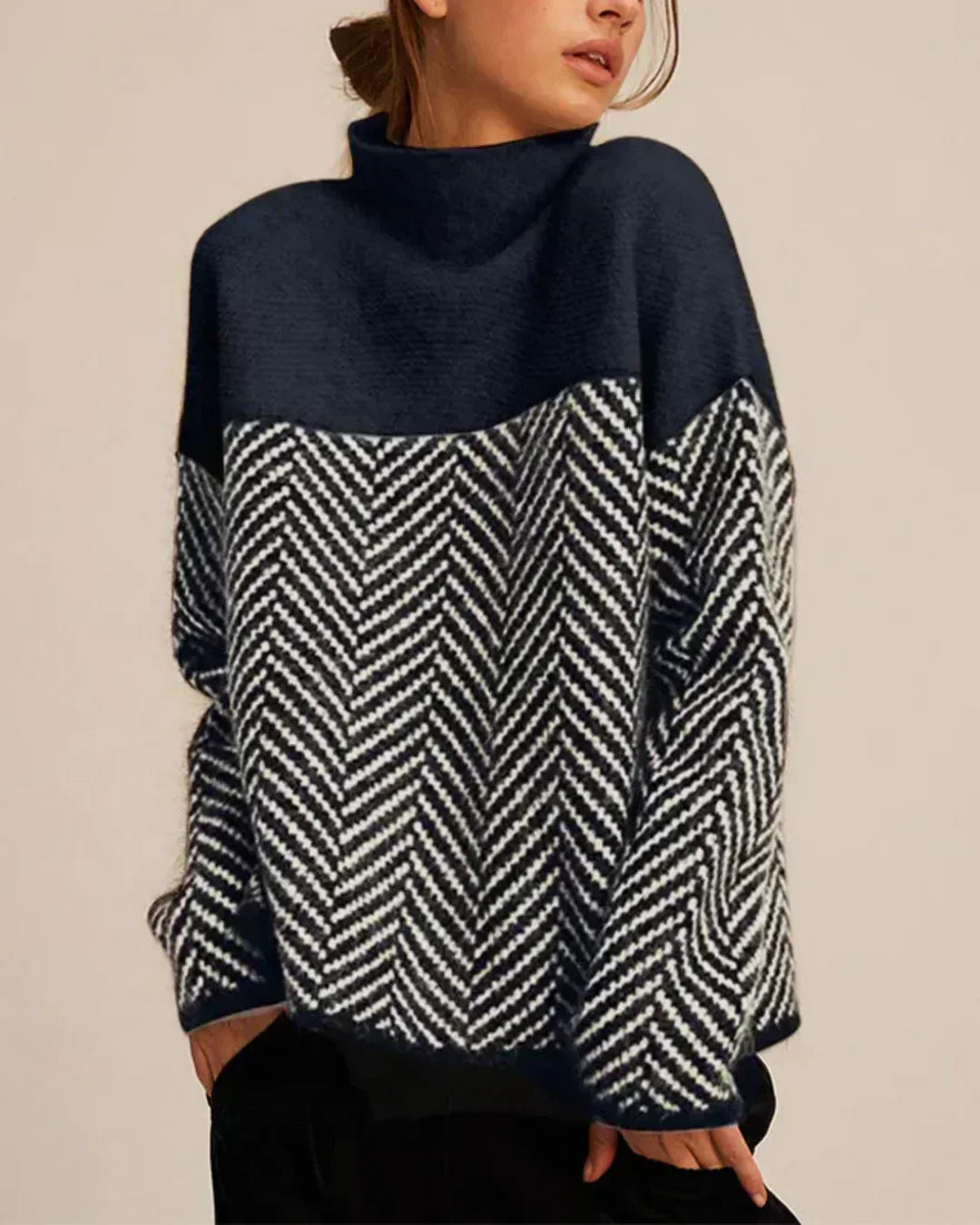 A woman wearing a zigzag-pattern funnel neck sweater styled elegantly for an fall day out.