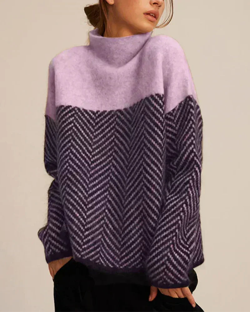 A woman wearing a zigzag-pattern funnel neck sweater styled elegantly for an fall day out.