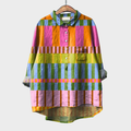 Woman wearing a colourful multicolour checked summer blouse with a soft, airy drape.
