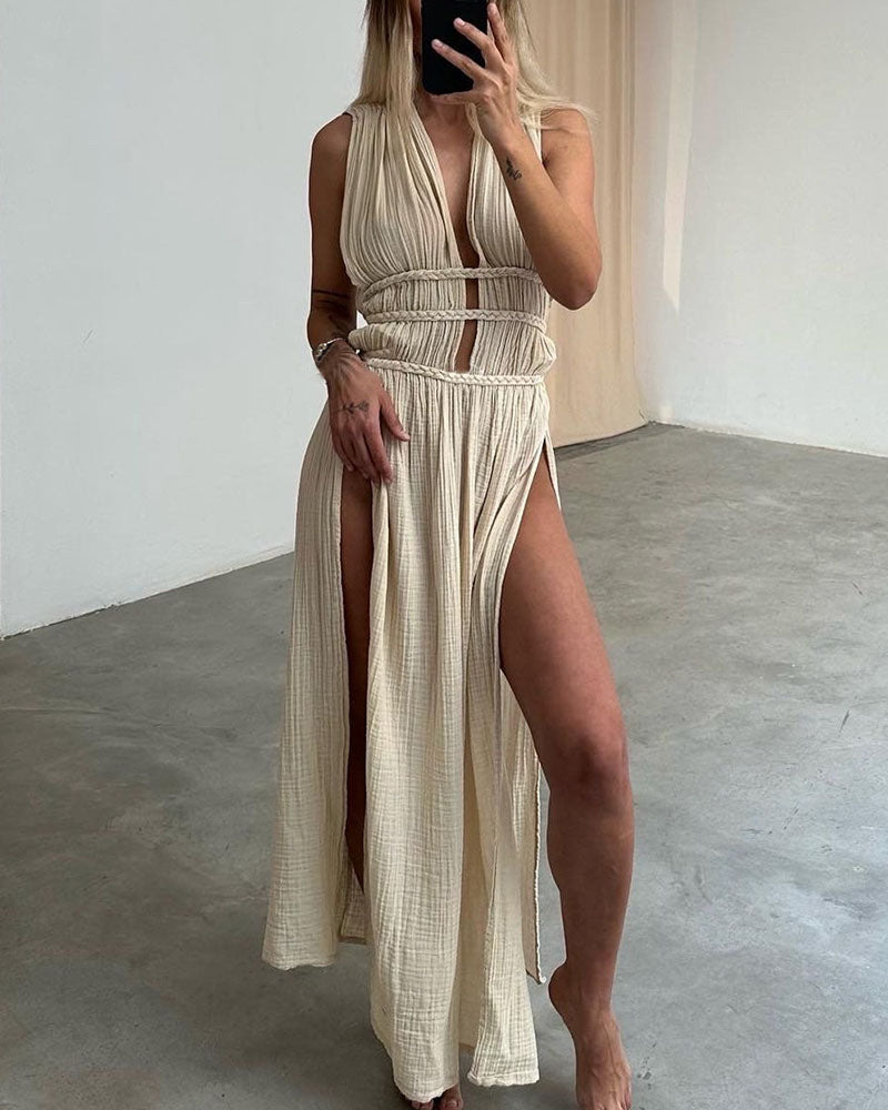 Woman in a softly textured dress with front slit and cinched waist tie at golden hour.