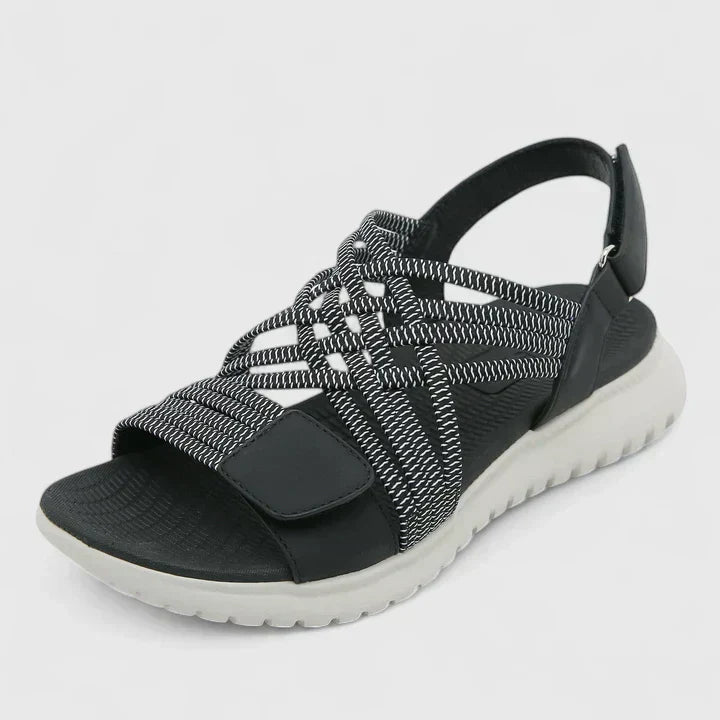 A woman walking freely in lightweight wide-fit orthopaedic sandals with an open front.