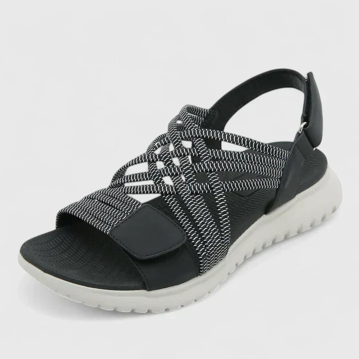 Blue open-toe sandals with woven stretch straps and a broad, cushioned white sole.