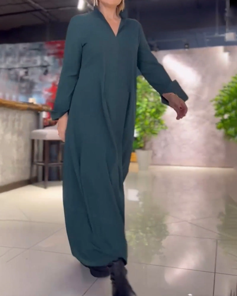 Woman wearing the Patricia relaxed maxi dress with revere collar, standing by a doorway.
