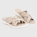 A woman in beige lightweight soft sandals walking easily on a sunny path, feet cushioned and supported.