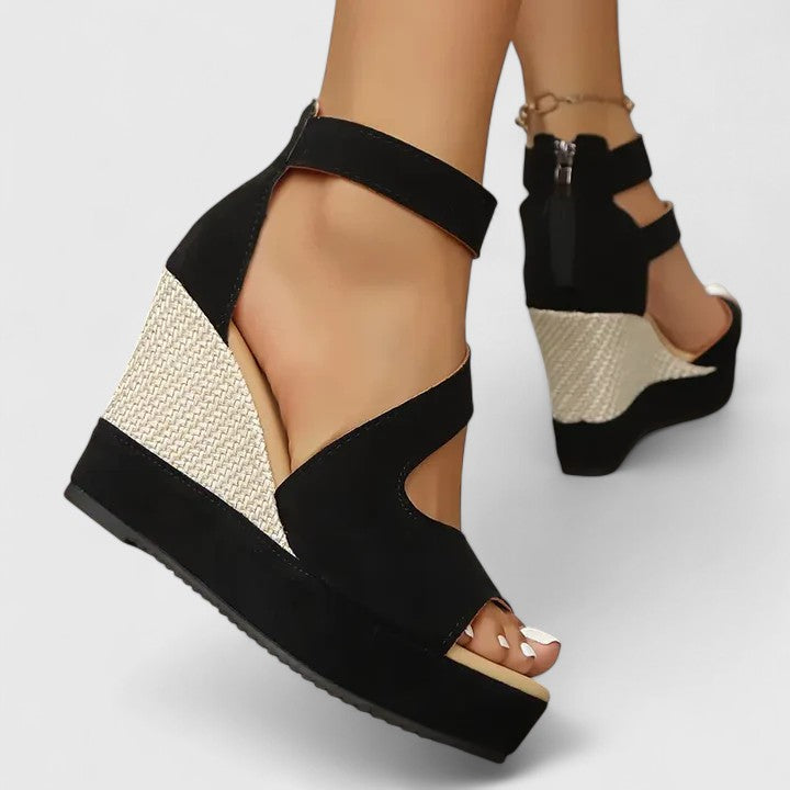 A woman walking gracefully in wide-fit wedge sandals with adjustable supportive straps.