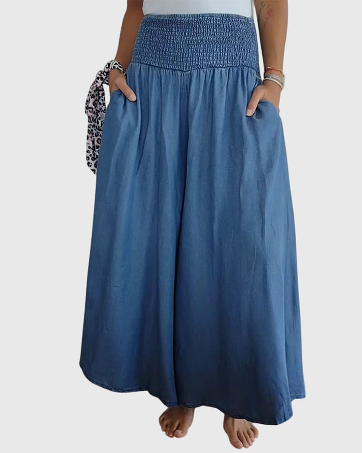 A woman in wide-leg pants with a high elastic waist, styled for a relaxed boho look.