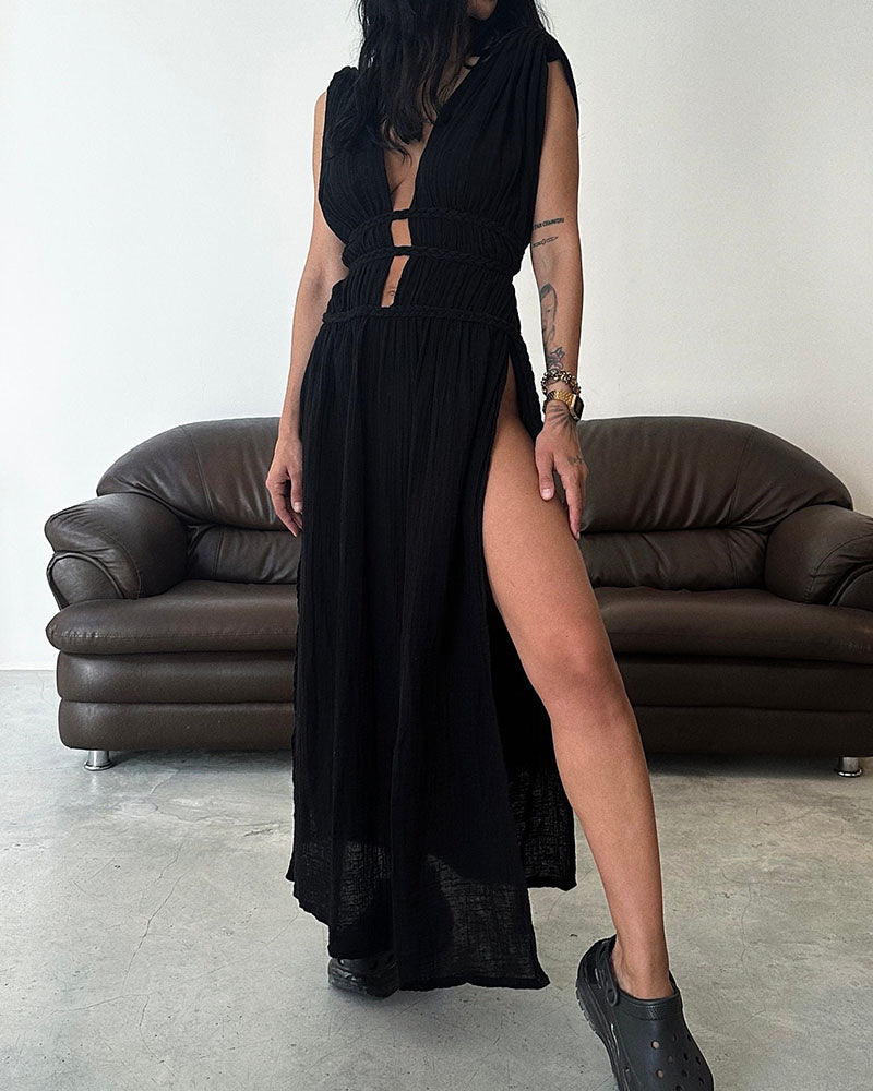 Woman in a softly textured dress with front slit and cinched waist tie at golden hour.