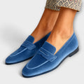 A woman wearing Soft-Touch loafers on an elegant day out.
