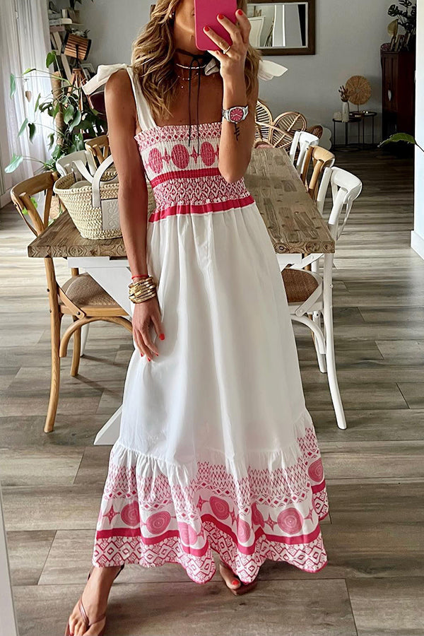 Woman wearing the Sara™ boho print maxi dress with a gathered bodice, enjoying a warm summer day outdoors.