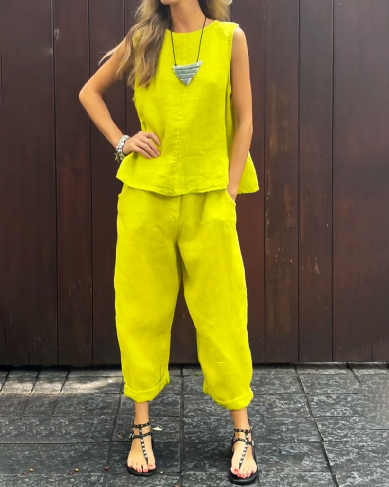 A woman wearing a relaxed sleeveless top with ankle-length pants, easy and elegant.