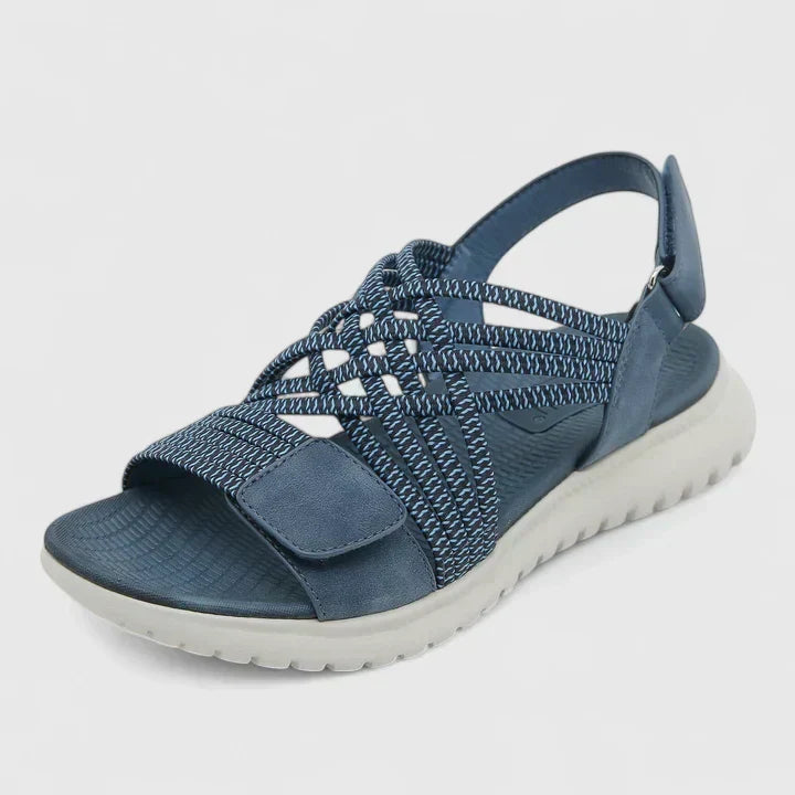 A woman walking freely in lightweight wide-fit orthopaedic sandals with an open front.