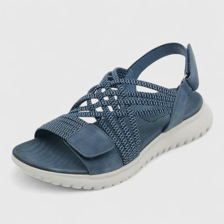 Blue open-toe sandals with woven stretch straps and a broad, cushioned white sole.