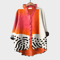 Woman wearing a light multicolour printed summer blouse with an easy, flattering fit.