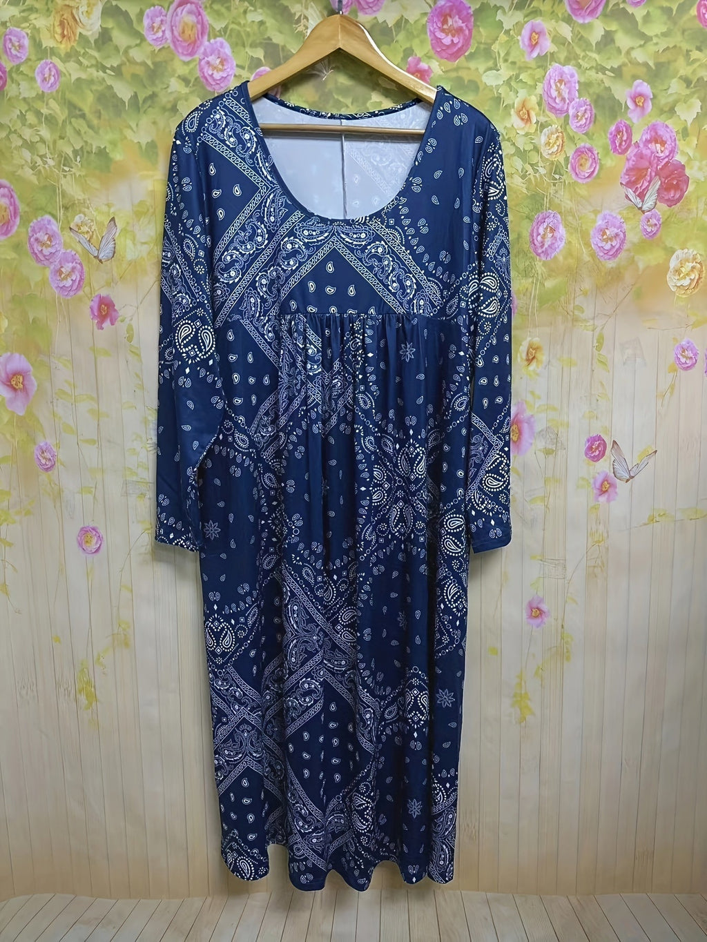 A woman wearing the Maria long sleeve grey paisley midi dress with a square neckline and flowing skirt, styled for a relaxed day out.