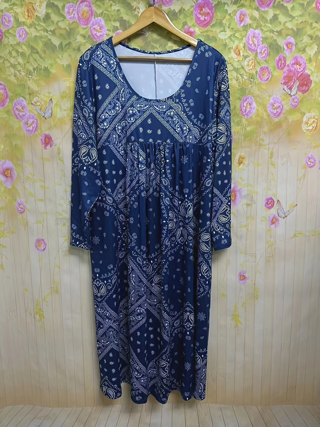 A woman wearing the Maria long sleeve grey paisley midi dress with a square neckline and flowing skirt, styled for a relaxed day out.