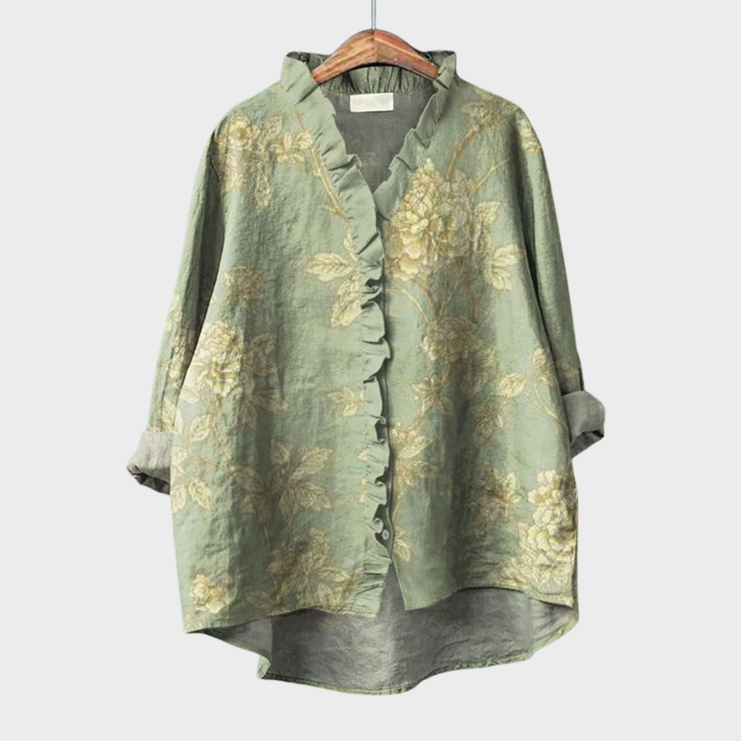 Woman wearing a green printed summer blouse with a soft, flowing fit.