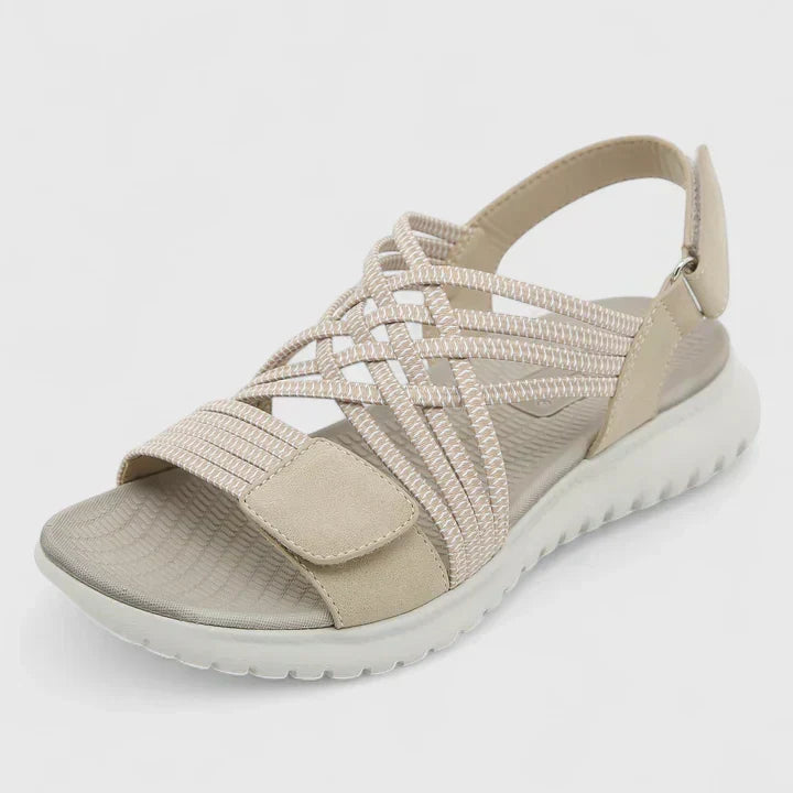 A woman walking freely in lightweight wide-fit orthopaedic sandals with an open front.