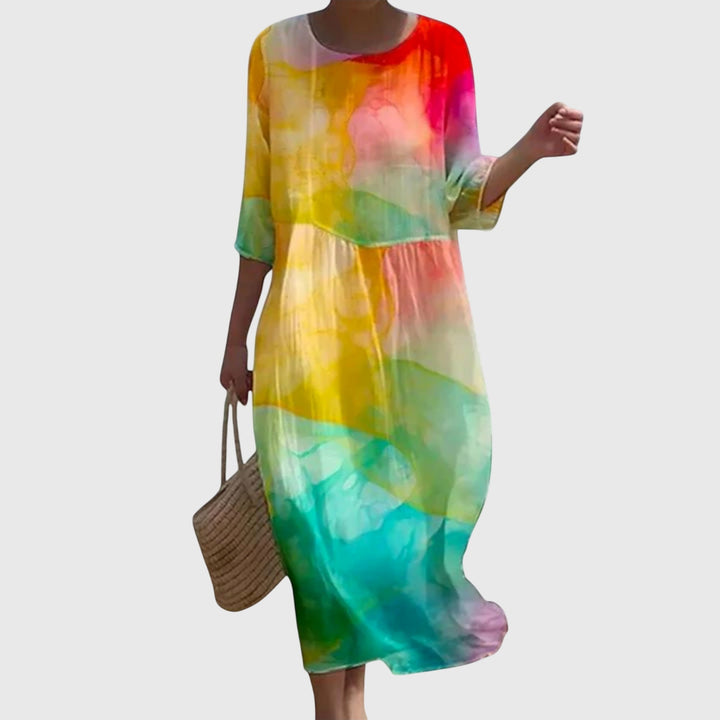 Woman wearing a long flowing maxi dress with a delicate floral print, moving gracefully.