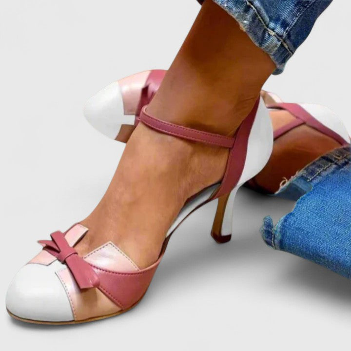 A woman wearing soft strap comfort heels, standing at ease in a light summer outfit.