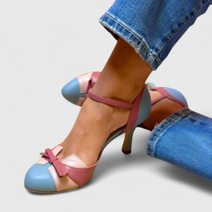 A woman wearing soft strap comfort heels, standing at ease in a light summer outfit.