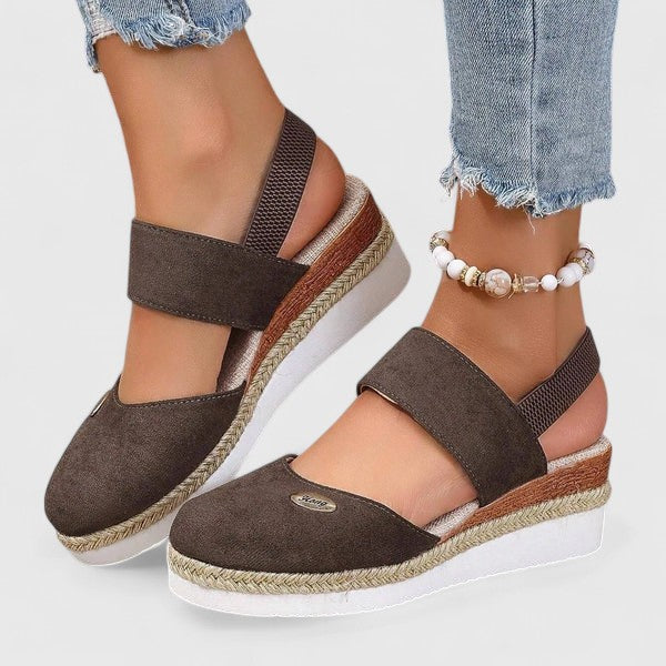 A woman in beige espadrille-inspired sandals stepping out comfortably on a bright morning.