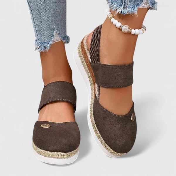 A woman in beige espadrille-inspired sandals stepping out comfortably on a bright morning.
