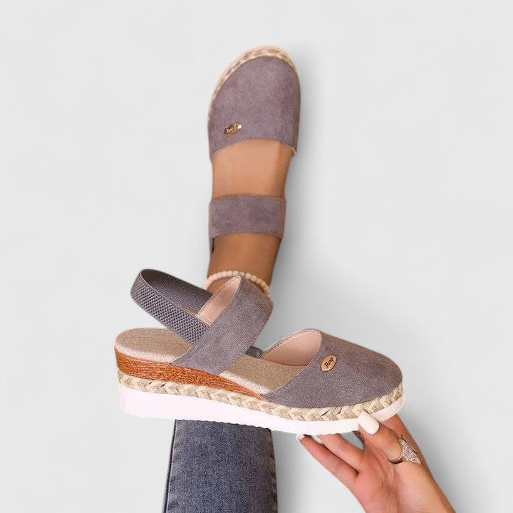 A woman in beige espadrille-inspired sandals stepping out comfortably on a bright morning.