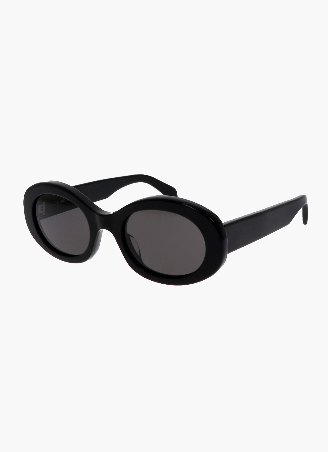 A woman wearing retro oval vintage sunglasses on a sunny day out.