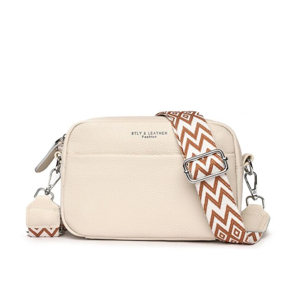 A woman wearing a timeless cross-body bag across her body while out and about