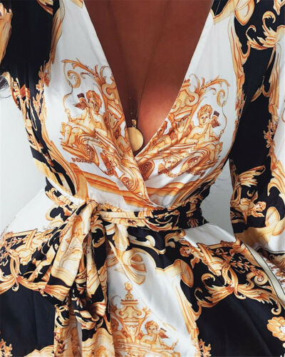 Woman at golden hour wearing the Eileen vintage print maxi dress with a waist belt and long statement sleeves.