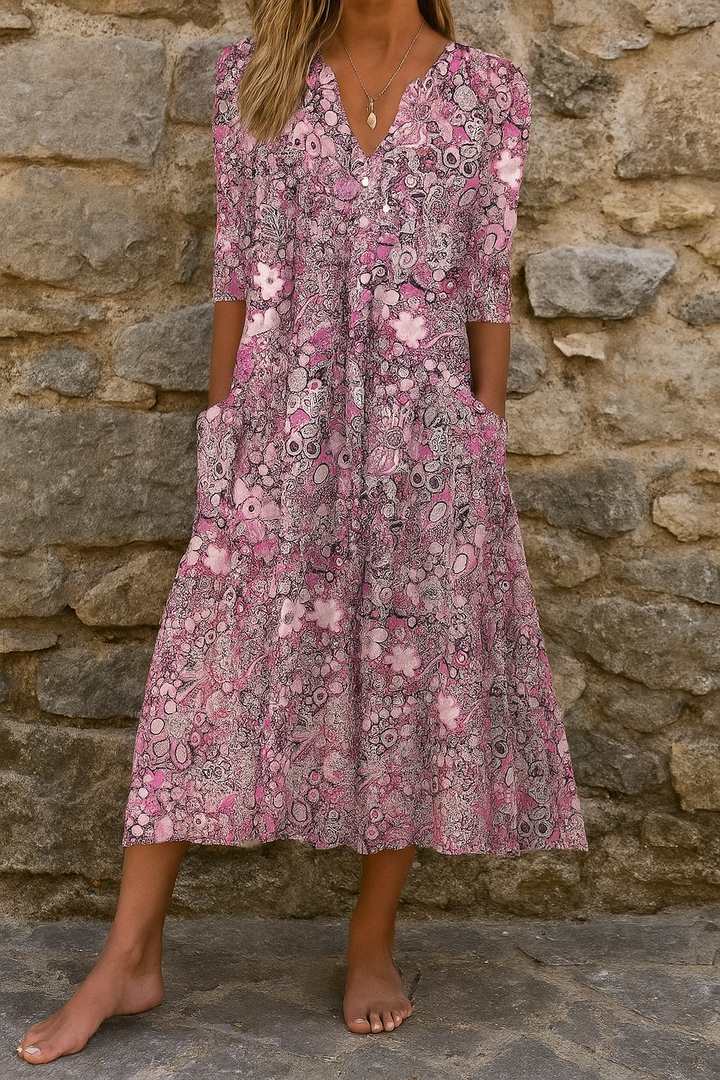 Woman wearing the Sandra elegant V-neck dress with three-quarter sleeves, walking through a city street.