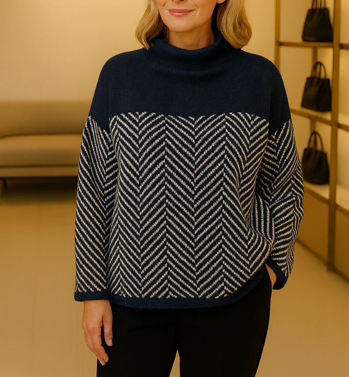 A woman wearing a zigzag-pattern funnel neck sweater styled elegantly for an fall day out.