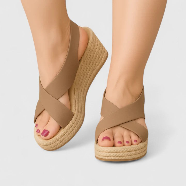 A woman in white crossover platform sandals standing comfortably, feet relaxed and supported.