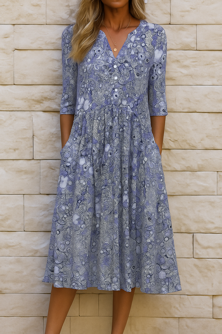 Woman wearing the Sandra elegant V-neck dress with three-quarter sleeves, walking through a city street.