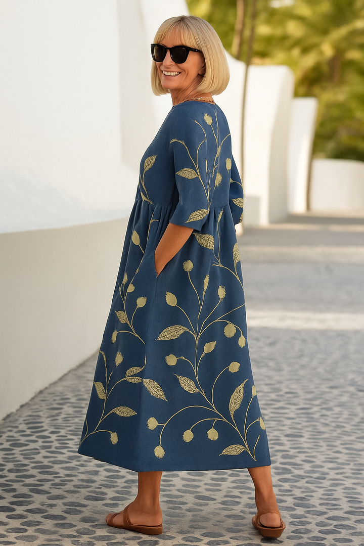 A woman wearing the Elizabeth relaxed floral midi dress with an A-line skirt, out for a daytime stroll.