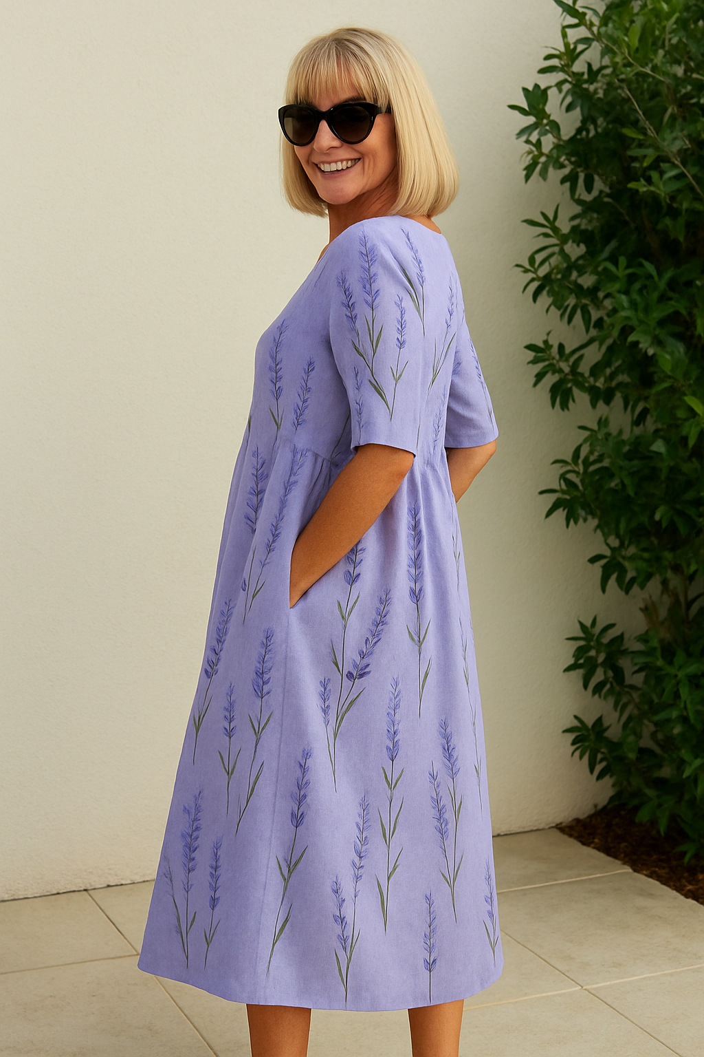 A woman wearing the Elizabeth relaxed floral midi dress with an A-line skirt, out for a daytime stroll.
