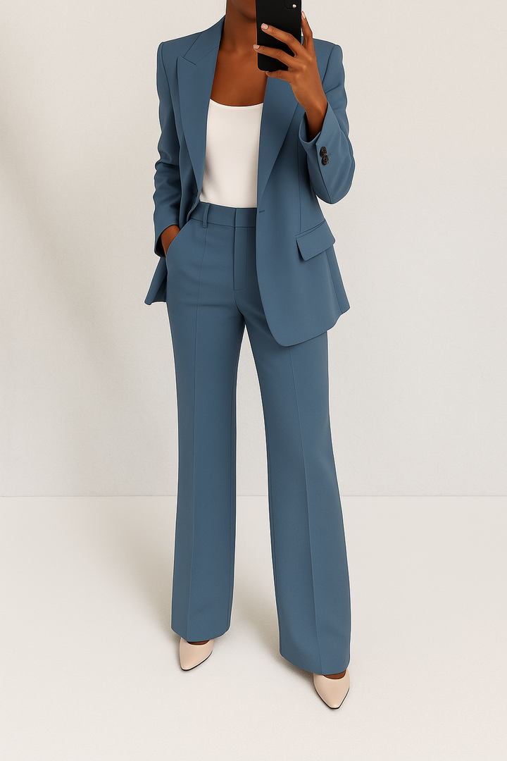 A woman wearing a tailored slim-fit blazer with matching pants.