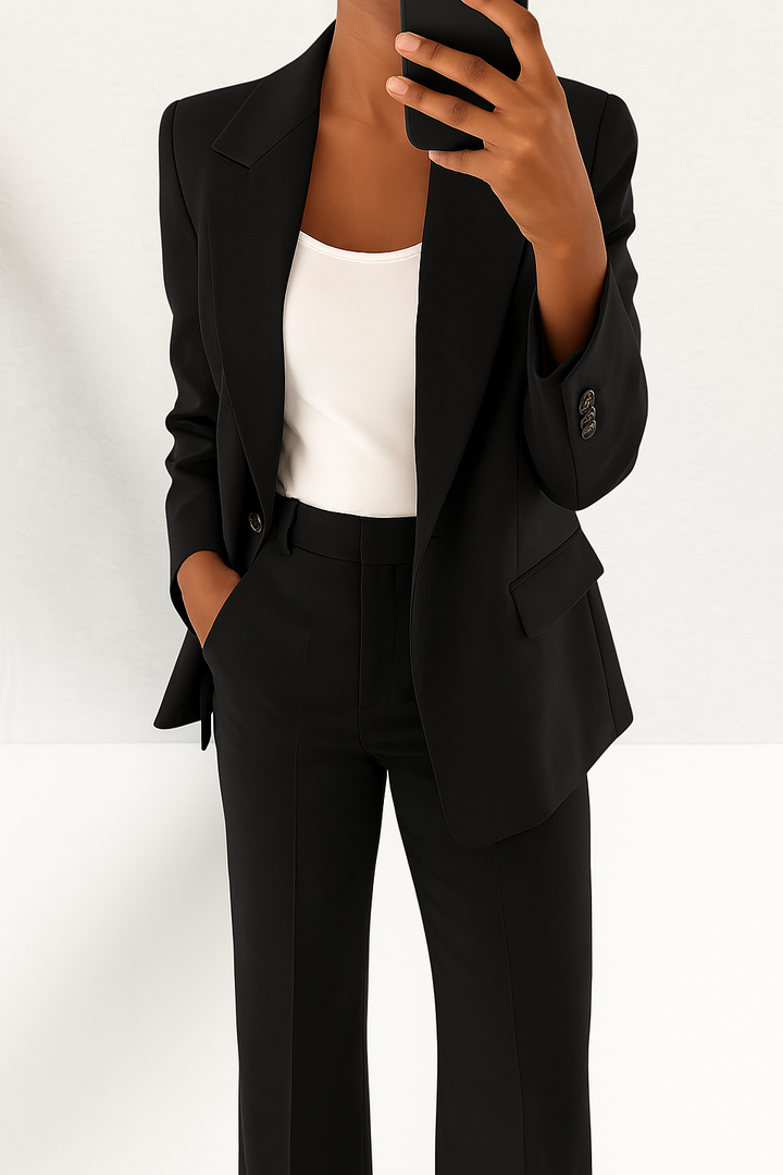 A woman wearing a tailored slim-fit blazer with matching pants.