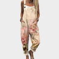 Woman wearing cream overalls with soft pink watercolour roses, adjustable straps, relaxed and graceful.