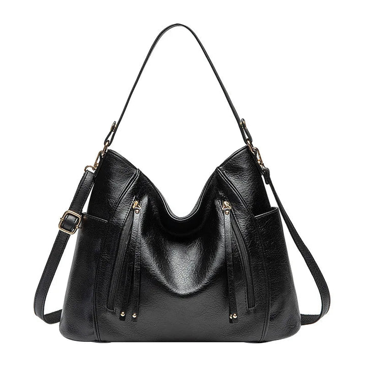 A woman wearing a fringed shoulder bag that sways gently as she walks through town.